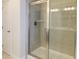 Large walk-in shower with tiled walls and a frameless glass door at 573 Auburn Crossing Dr, Auburn, GA 30011