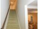 Carpeted staircase with wooden handrail leading upstairs at 573 Auburn Crossing Dr, Auburn, GA 30011
