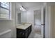 Bathroom with dark vanity, toilet and window at 132 Bishop Nw Rd, Cartersville, GA 30121