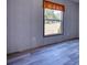 Simple bedroom with wood-look flooring and a window overlooking yard at 5752 Hancock Dr, Social Circle, GA 30025