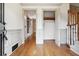 Bright entryway with hardwood floors, coat closet, and view to hallway at 5417 Trentham Dr, Dunwoody, GA 30338