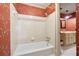 Clean bathroom with tub and shower, featuring tiled walls at 5417 Trentham Dr, Dunwoody, GA 30338