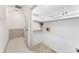 Bright laundry room with white cabinets and flooring at 5417 Trentham Dr, Dunwoody, GA 30338