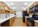 Kitchen with wood cabinets, black appliances, and hardwood floors at 5417 Trentham Dr, Dunwoody, GA 30338