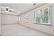 Bright primary bedroom with multiple windows and neutral carpeting at 5417 Trentham Dr, Dunwoody, GA 30338