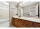 Bathroom with double vanity, wood cabinets, and a separate tub and shower at 5417 Trentham Dr, Dunwoody, GA 30338
