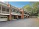 Townhome complex showcasing multiple units, garages, and screened porches at 5417 Trentham Dr, Dunwoody, GA 30338