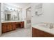 Double vanity bathroom with wood cabinets and a separate tub at 5417 Trentham Dr, Dunwoody, GA 30338