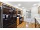 Bright kitchen with wood cabinets, black appliances, and hardwood floors at 5417 Trentham Dr, Dunwoody, GA 30338