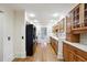 Galley kitchen with wood cabinets, black appliances, and hardwood floors at 5417 Trentham Dr, Dunwoody, GA 30338