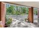 Brick patio with scenic wooded views and potted plants at 5417 Trentham Dr, Dunwoody, GA 30338