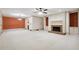 Open living room with fireplace, built-in shelving, and access to dining area at 5417 Trentham Dr, Dunwoody, GA 30338