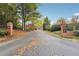Community entrance with brick pillars and landscaping at 5417 Trentham Dr, Dunwoody, GA 30338