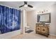 Bathroom with a shower/tub combo, vanity with a mirror, and patterned shower curtain at 9140 N Links Dr, Covington, GA 30014