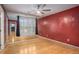 Bedroom with hardwood floors and mirrored wall at 9140 N Links Dr, Covington, GA 30014