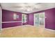 Spacious basement room with purple walls, tile floor, and sliding glass doors at 9140 N Links Dr, Covington, GA 30014