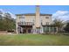 Back view of a two-story house with a deck, sunroom, and grassy yard at 9140 N Links Dr, Covington, GA 30014