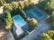 Aerial view of community pool and tennis courts with surrounding trees at 9140 N Links Dr, Covington, GA 30014