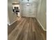 Dining area with rustic wood accent wall, modern light fixture, and adjacent kitchen at 425 Warm Springs Cir, Roswell, GA 30075