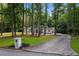 Front view of house with long driveway and mailbox at 2023 Stoneleigh Dr, Stone Mountain, GA 30087