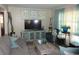Living room with gray sofas, light blue accents, and a large TV at 1318 Shoreham Dr, Atlanta, GA 30349