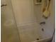 Clean shower with tub, tiled walls, and glass door at 1318 Shoreham Dr, Atlanta, GA 30349