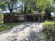 Brick ranch house with carport, large yard, mature trees, and landscaping at 1318 Shoreham Dr, Atlanta, GA 30349