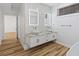 Double vanity with marble countertop and modern fixtures in basement bath at 1711 Summit Glen Ln, Atlanta, GA 30329