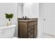 Modern bathroom with brown vanity and granite countertop at 1633 Baytree Dr, Cumming, GA 30040