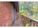 Brick building with wooden deck and railing, surrounded by trees at 2314 Omaha Sw Rd, Atlanta, GA 30331