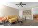 Living room featuring a mustard-colored sectional sofa and ceiling fan at 2314 Omaha Sw Rd, Atlanta, GA 30331