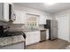 Renovated kitchen with white shaker cabinets and granite countertops at 2435 Wood Valley Dr, Atlanta, GA 30344