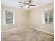Well-lit bedroom with ceiling fan and two windows at 3449 Misty Valley Rd, Decatur, GA 30032