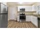 Updated kitchen with stainless steel appliances and back door access at 3449 Misty Valley Rd, Decatur, GA 30032
