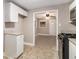 Kitchen with white cabinets, granite countertops, and view to dining area at 1870 S Columbia Pl, Decatur, GA 30032
