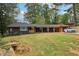 Mid-century modern home with a dark exterior and a spacious lawn at 1973 Glendale Dr, Decatur, GA 30032