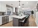 Modern kitchen boasts white cabinets, a large island, and stainless steel appliances at 1973 Glendale Dr, Decatur, GA 30032