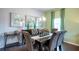 Bright dining room with dark wood table and gray upholstered chairs at 624 Kimberwick Dr, Locust Grove, GA 30248