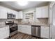 Updated kitchen, featuring granite countertops and stainless steel appliances at 2604 Harmony Way, Atlanta, GA 30344