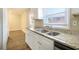 Bright kitchen features granite countertops, white cabinets, and stainless steel sink at 2910 Delowe Dr, Atlanta, GA 30344