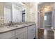 Bathroom with granite countertop, white cabinets and view of hallway at 2910 Delowe Dr, Atlanta, GA 30344