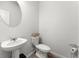 Small half bathroom with pedestal sink and circular mirror at 1840 Fabian Sw Way, Austell, GA 30106