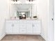 Modern bathroom with double vanity, large mirror, and tile flooring at 1641 Mcnaught Dr # 35, Atlanta, GA 30317