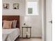 Bedroom with wood headboard, nightstand, and window at 1641 Mcnaught Dr # 35, Atlanta, GA 30317