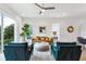 Bright living room with stylish teal armchairs and a comfy leather sofa at 1641 Mcnaught Dr # 35, Atlanta, GA 30317