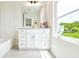 Bathroom with white vanity, subway tile, and a window at 1641 Mcnaught Dr # 35, Atlanta, GA 30317