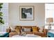 Living room features a leather sofa with accent pillows and modern art at 1641 Mcnaught Dr # 35, Atlanta, GA 30317