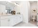 Double vanity bathroom with white cabinets and gray tile floor at 1641 Mcnaught Dr # 35, Atlanta, GA 30317