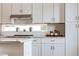 Modern kitchen with white cabinets, stainless steel appliances, and a quartz countertop at 1641 Mcnaught Dr # 35, Atlanta, GA 30317