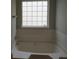 Bathroom with a large tub and window at 6511 Grey Fox Way, Riverdale, GA 30296